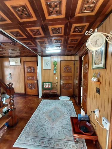 a living room with a coffered ceiling and a rug at Grandmother's Vegetable garden in Anseong