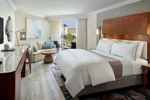 a bedroom with a large bed and a living room at The Westin Hilton Head Island Resort & Spa in Hilton Head Island