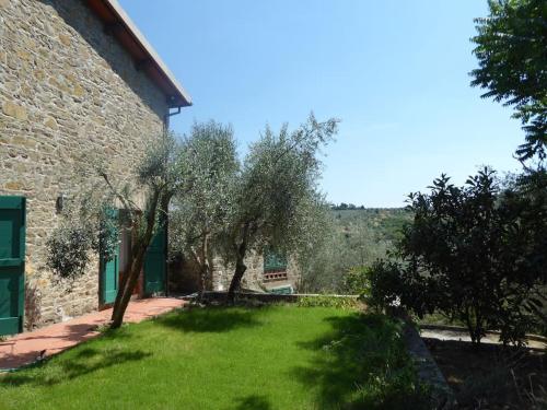 a garden with trees next to a building at Podere Solatio - Tuscany Hills next to Florence in Impruneta