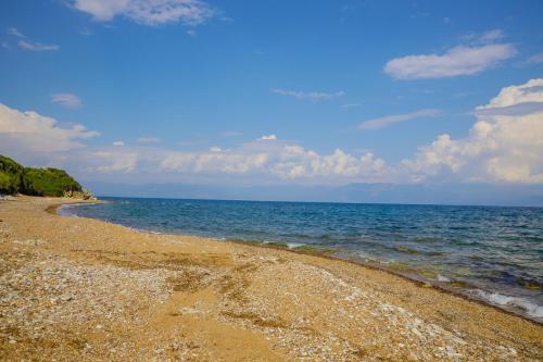 a rocky beach with the ocean in the background at Alethea's Sea View Apartment in Kalamaki