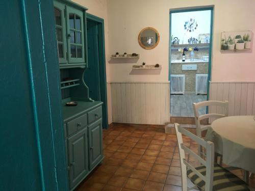 a kitchen with a green cabinet and a table at Casa Mamatita in Agüimes