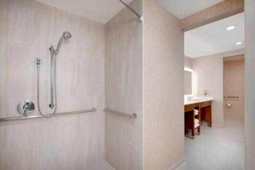 a bathroom with a shower and a sink at The Westin Dallas Park Central in Dallas