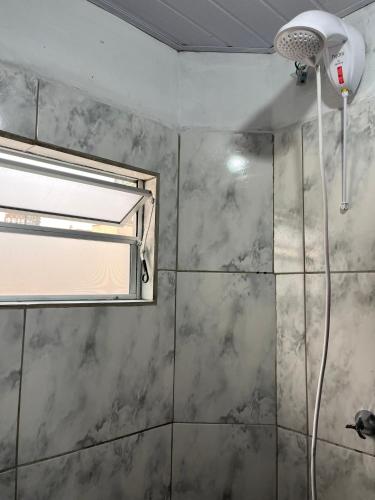 a bathroom with a shower with a window at Apartamento no Centro de Blumenau in Blumenau