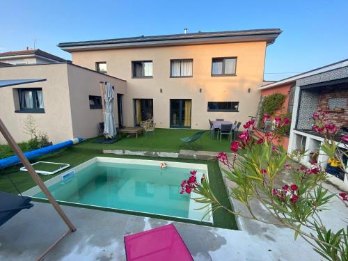 une cour arrière avec une piscine et une maison dans l'établissement Maison élégante, à Besançon