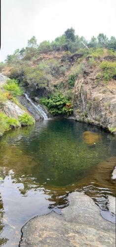 a pool of water in the middle of a river at Refúgio dos Mauzinhos in Ourondo