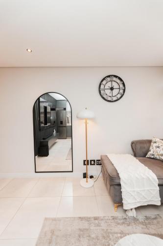 a living room with a couch and a mirror at The paramount in Johannesburg