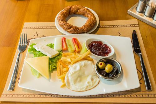 a plate of food with cheese and a pretzel at Accra Luxury Apartments at Embassy Gardens in Accra