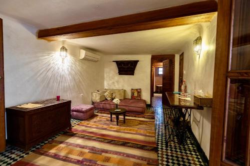 a living room with a couch and a table at Dar Attajalli in Fès
