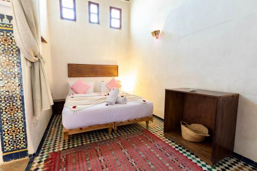 a bedroom with a bed in a room at Dar Attajalli in Fès
