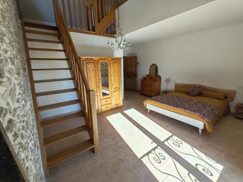 a bedroom with a bed and a stair case at La Source Du Bonheur Chambres et Table d'Hôtes in Rieupeyroux