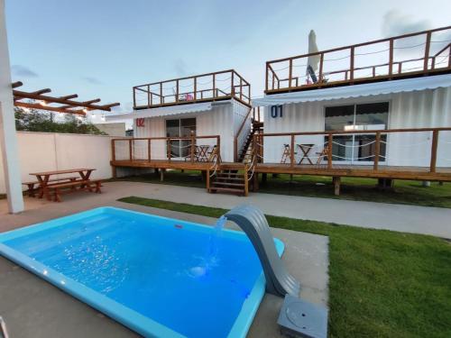 a house with a swimming pool and a house at Lages in Box - Casa por temporada na Rota dos Milagres - Porto de Pedras in Tatuamunha