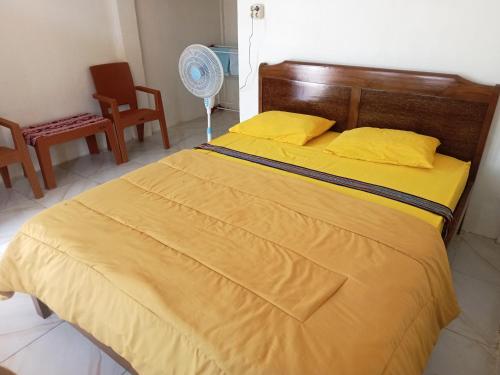 Ένα ή περισσότερα κρεβάτια σε δωμάτιο στο D'Flores Guest House