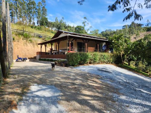 a house with a dog standing in front of it at Casa do Campo in Rio do Sul