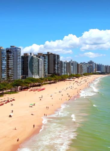 people on the beach in front of a city at Ed MORADA MAR DO LESTE in Itaparica