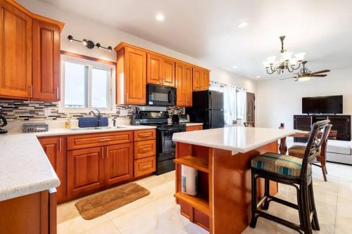 a large kitchen with wooden cabinets and a counter top at Hilo Manu Iki Ohana in Hilo