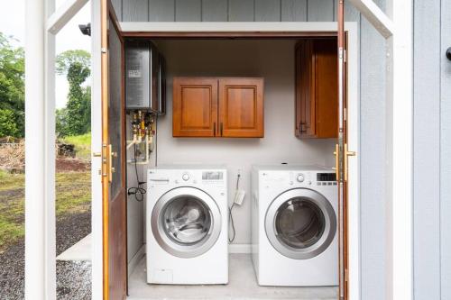 a house with a washer and dryer in a garage at Hilo Manu Iki Ohana in Hilo