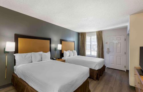 a hotel room with two beds and a window at Extended Stay America Select Suites - Denver - Cherry Creek in Denver