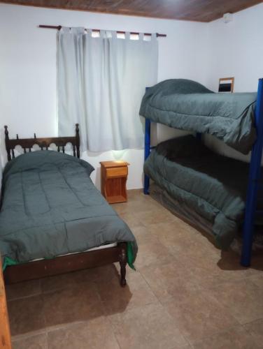 a bedroom with two bunk beds and a window at Los 3 soles in Villa Ciudad Parque