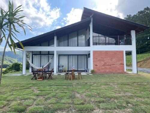 BlinhaにあるCasa de Campo em Presidente Nereu - SCのハンモックが前に置かれた家