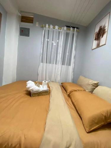 a bedroom with two beds in front of a window at Nics Studiotel - Massage chair in Concepcion