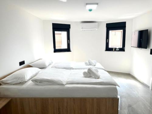 a bed with two teddy bears sitting on top of it at BLUE SKY Apartments in Sarajevo