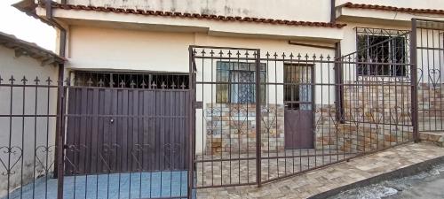 a house with a gate in front of it at Casa para temporada in Ouro Preto