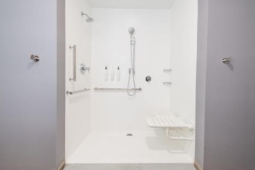 a bathroom with white walls and a shower stall at SpringHill Suites by Marriott Baltimore Downtown Convention Center Area in Baltimore