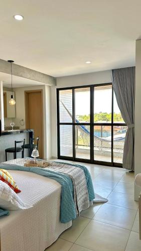 a bedroom with a bed and a view of a kitchen at (308) Studio Âncora | Your Refuge in Holandeses in Vinhais