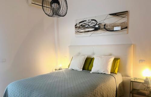 a bedroom with a bed with yellow and white pillows at Melo Home 1 Near Airport, Elevator in Vecindario