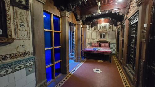 a hallway with a bed in the middle of a building at The Prince Haveli in Bikaner
