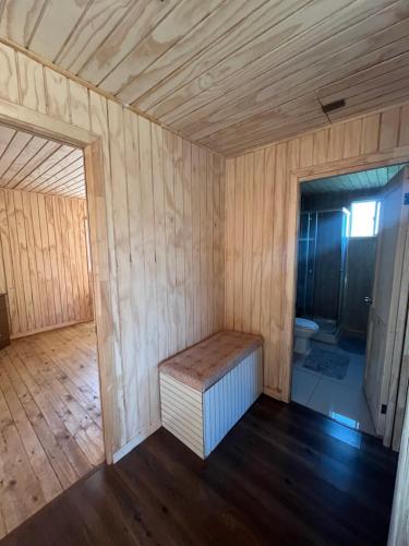 a room with a bench and a toilet in it at Quilquico Lodge in Castro