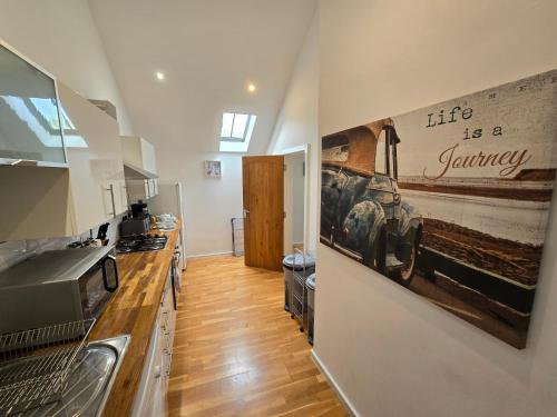 a kitchen with a picture of a car on the wall at Naval base Quietness Parking LongStays 6Guests in Plymouth