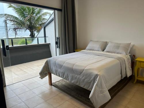 Ένα ή περισσότερα κρεβάτια σε δωμάτιο στο Casa Beira Mar