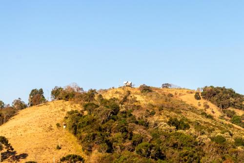 a hill with trees on top of it at Chalé Serra dos tucanos in Gonçalves