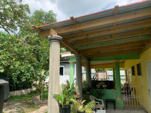 a wooden pergola on top of a house at SHALOM SUITE 3 in Kingston