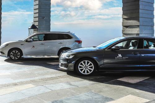 two cars are parked next to each other at Weligama Bay Marriott Resort & Spa in Weligama
