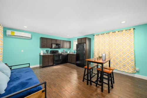a living room with a table and a kitchen at Stylish 1BR Apt - Steps from NRG and Texas Med Center in Houston