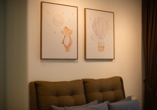 three pictures on a wall above a couch at Afiniti 2BR - Giant Bear Home - Legoland 300m in Nusajaya