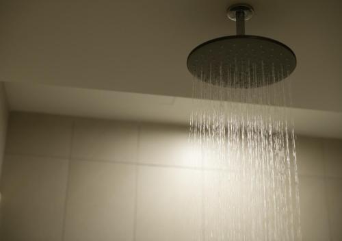 a shower with a droplet of water hanging from a ceiling at Afiniti 2BR - Giant Bear Home - Legoland 300m in Nusajaya