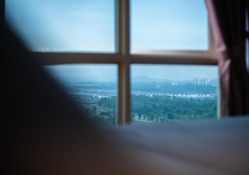a window with a view of a city at Afiniti 2BR - Giant Bear Home - Legoland 300m in Nusajaya