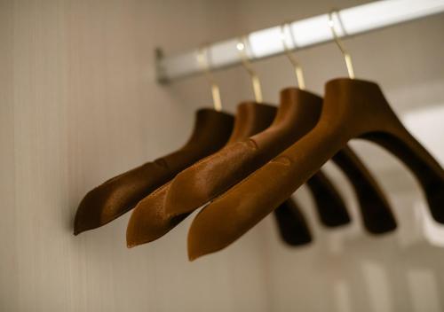 a group of brown hot dogs hanging on a rack at Afiniti 2BR - Giant Bear Home - Legoland 300m in Nusajaya