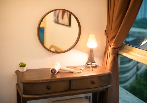 a dressing table with a mirror and a lamp at Afiniti 2BR - Giant Bear Home - Legoland 300m in Nusajaya