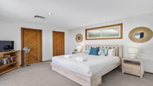 a bedroom with a large bed and a tv at Zaffiro Beach House - Accessible, Pool, Beach, Sleeps 8 in Sapphire Beach