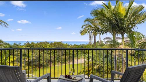 a balcony with a view of the ocean and palm trees at Zaffiro Beach House - Accessible, Pool, Beach, Sleeps 8 in Sapphire Beach