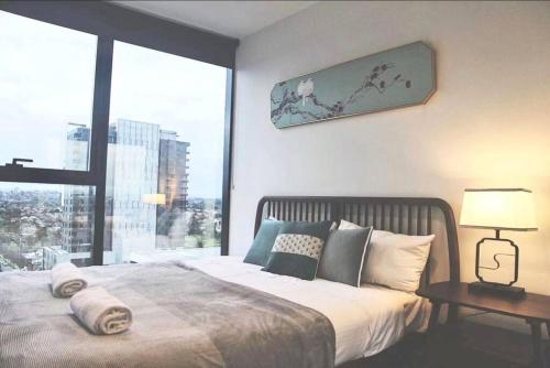 a bedroom with a large bed and a large window at WT917 - 2BR 2BTH in heart of box hill with free park & pool in Box Hill