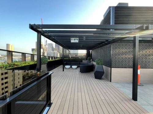 a rooftop deck with couches and chairs on a building at WT917 - 2BR 2BTH in heart of box hill with free park & pool in Box Hill
