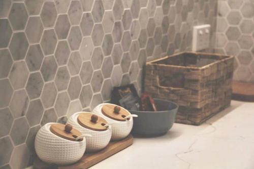 a group of bowls on a shelf next to a wall at WT917 - 2BR 2BTH in heart of box hill with free park & pool in Box Hill