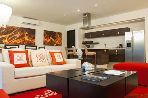 a living room with a couch and a table at Marival Distinct All-Suites & World Spa - Handwritten Collection in Nuevo Vallarta 