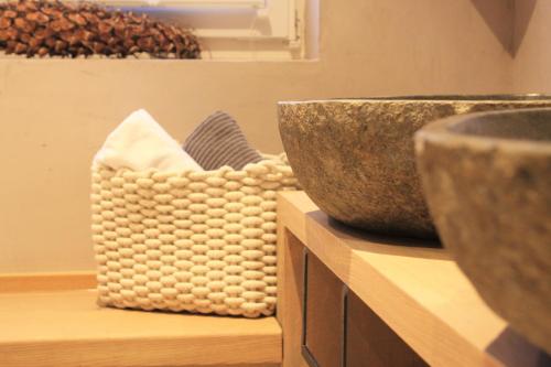 a group of bowls sitting on a wooden shelf at Dorfplatzl in Ischgl