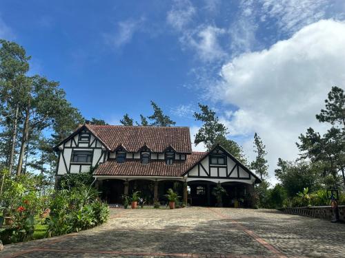 a large black and white house with a roof at Cerro Azul Mountain Retreat in Cerro Azul